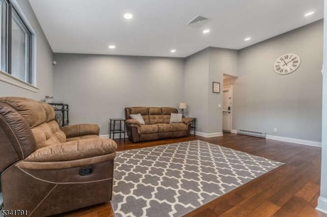 living room featuring visible vents, recessed lighting, baseboards, and wood finished floors