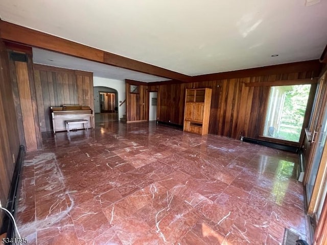 unfurnished living room with a baseboard heating unit, arched walkways, beam ceiling, and wooden walls