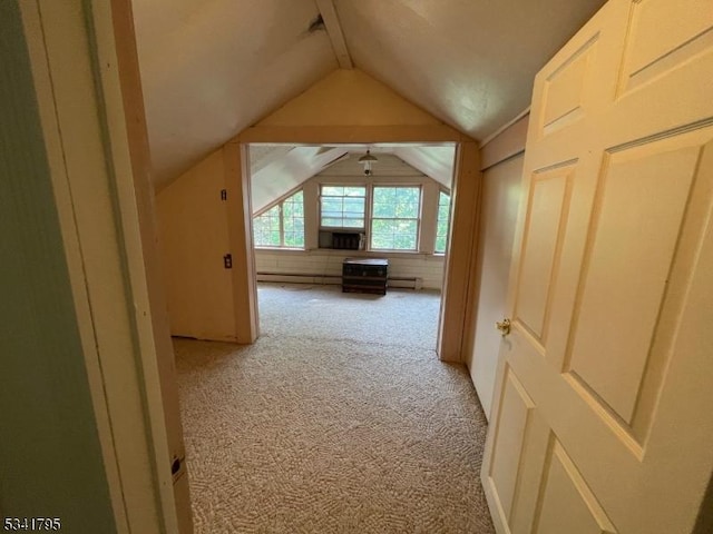 additional living space featuring light carpet, a baseboard radiator, lofted ceiling, and cooling unit