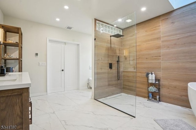 full bathroom featuring a walk in shower, recessed lighting, vanity, visible vents, and marble finish floor