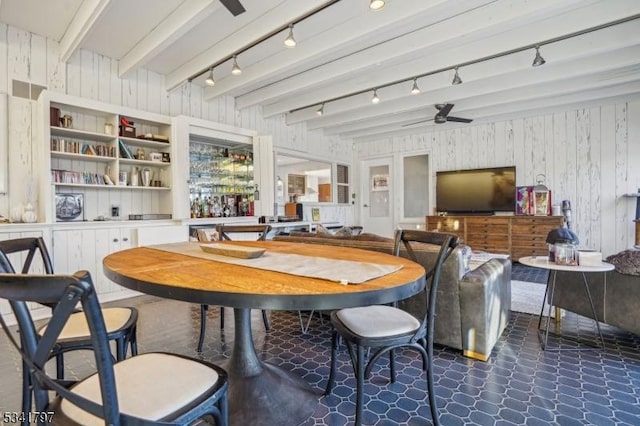 dining space with rail lighting, a ceiling fan, and beam ceiling