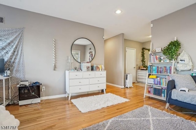 interior space featuring recessed lighting, visible vents, baseboards, and wood finished floors