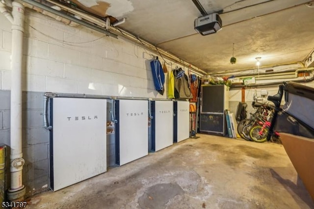 basement featuring a garage and concrete block wall