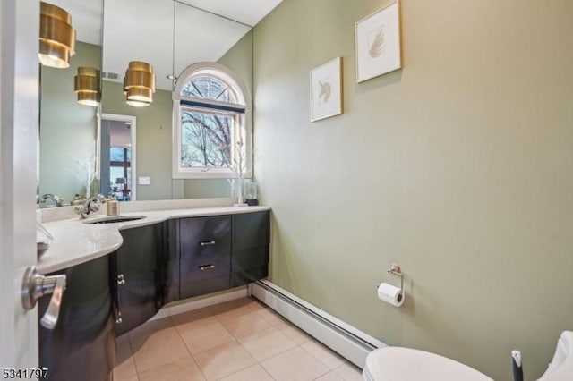 half bathroom featuring visible vents, toilet, tile patterned flooring, baseboard heating, and vanity