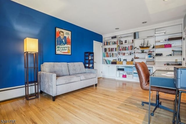 office area featuring a baseboard heating unit and light wood finished floors