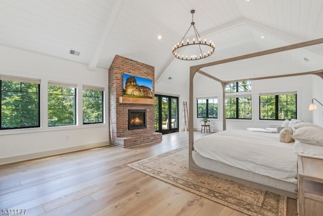 bedroom featuring high vaulted ceiling, a fireplace, wood finished floors, visible vents, and beamed ceiling