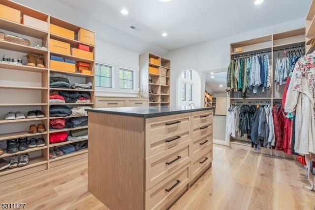 walk in closet with light wood finished floors and visible vents