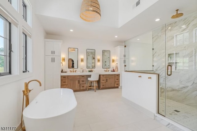 full bath with a marble finish shower, visible vents, a soaking tub, vanity, and recessed lighting