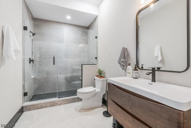 bathroom featuring tile patterned flooring, vanity, toilet, and a shower stall