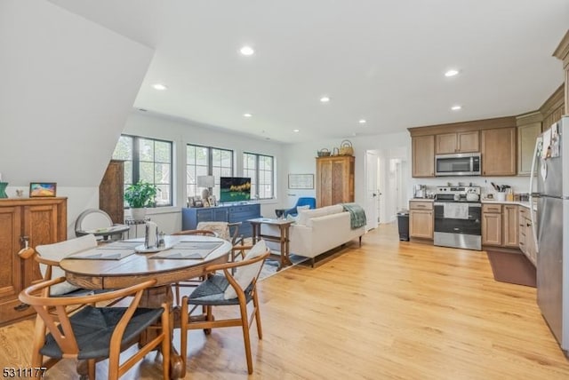 dining area with recessed lighting and light wood-style flooring