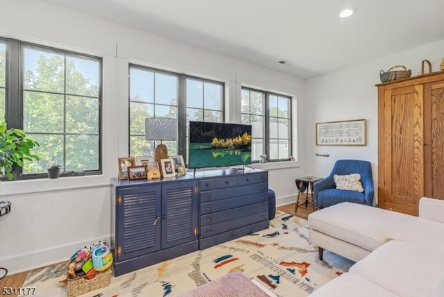 interior space featuring baseboards, wood finished floors, and recessed lighting