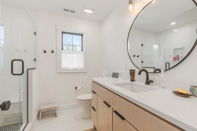 bathroom featuring a stall shower, visible vents, and toilet