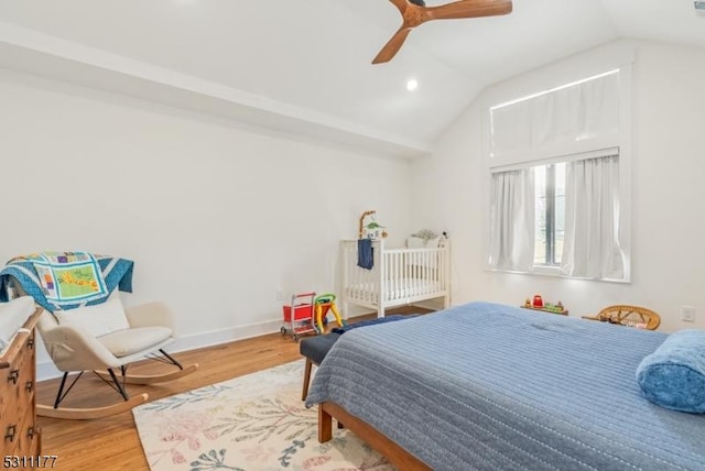 bedroom with ceiling fan, vaulted ceiling, baseboards, and wood finished floors