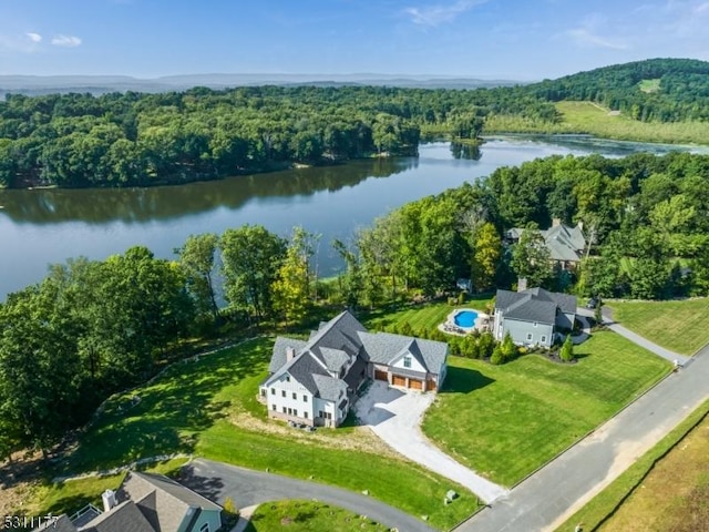 aerial view featuring a water view and a wooded view