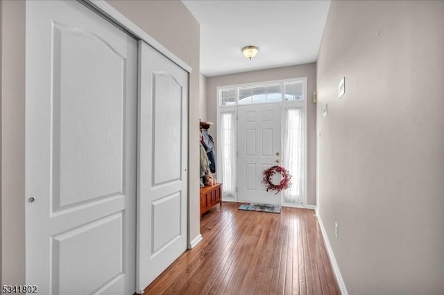 entrance foyer featuring baseboards and hardwood / wood-style floors