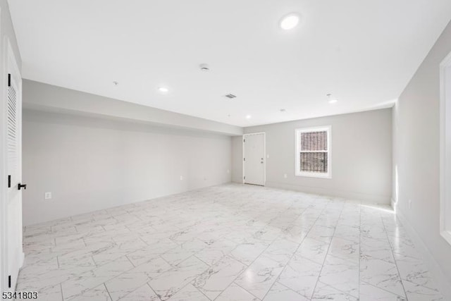 unfurnished room with marble finish floor, visible vents, and recessed lighting