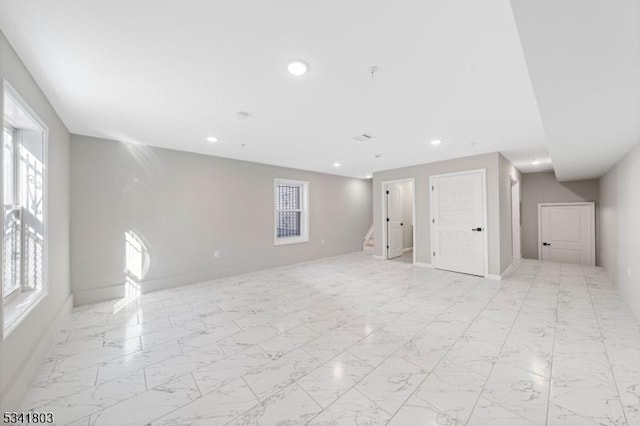 interior space featuring stairs, marble finish floor, recessed lighting, and a healthy amount of sunlight