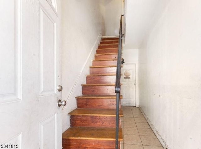 staircase featuring tile patterned floors