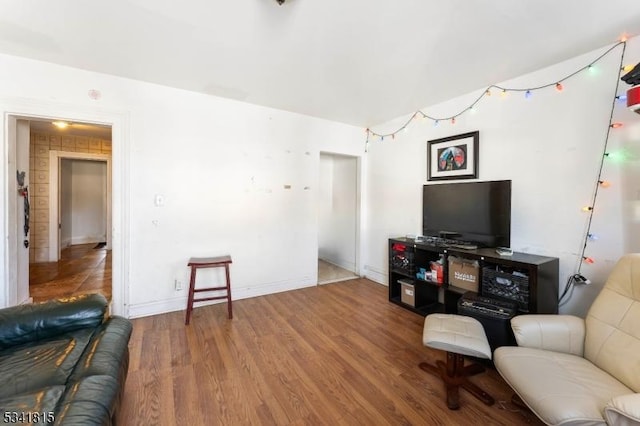 living area with wood finished floors and baseboards