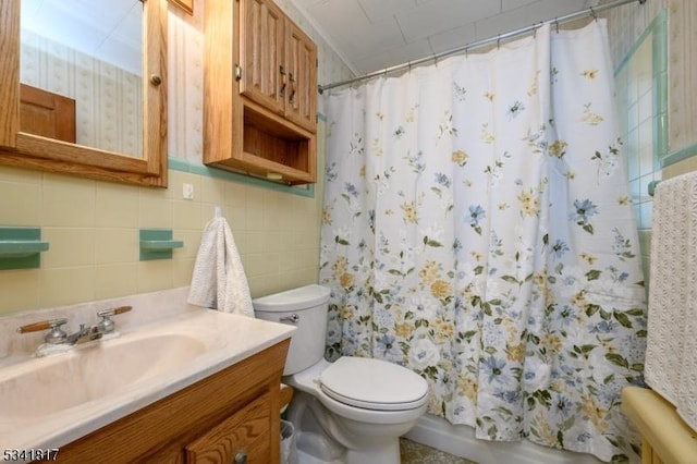 bathroom with shower / bath combo, tile walls, toilet, and vanity