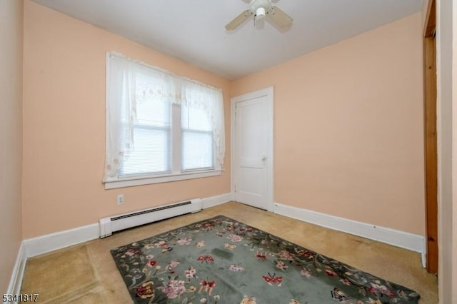 empty room with a baseboard radiator, ceiling fan, and baseboards