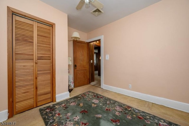 unfurnished bedroom with carpet, a closet, visible vents, and baseboards