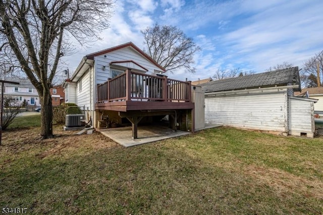 back of house featuring a patio area, a lawn, a wooden deck, and central AC unit