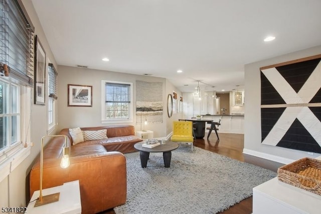 living room featuring dark wood-style floors, recessed lighting, and visible vents