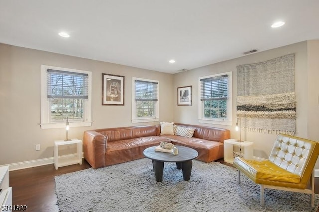 living room with baseboards, wood finished floors, visible vents, and recessed lighting