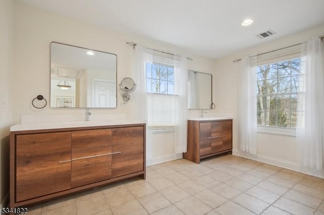 bathroom with recessed lighting, visible vents, baseboards, and vanity