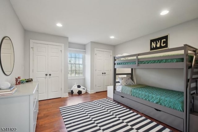 bedroom with recessed lighting, baseboards, multiple closets, and wood finished floors