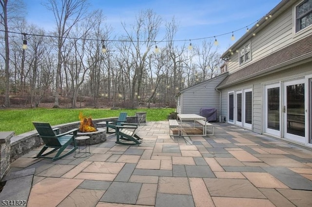 view of patio with french doors and an outdoor fire pit