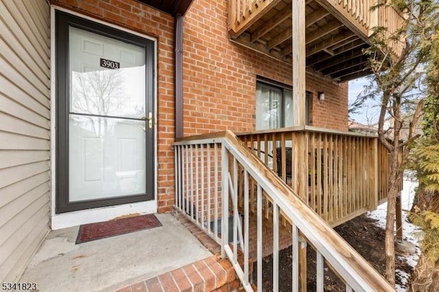 doorway to property featuring brick siding