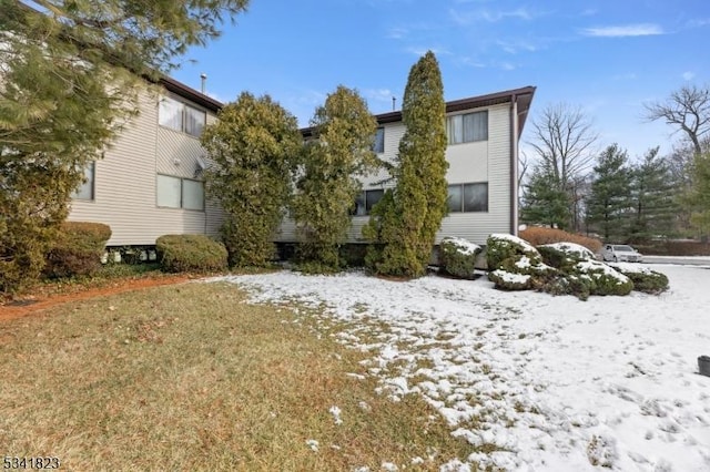 view of snow covered rear of property