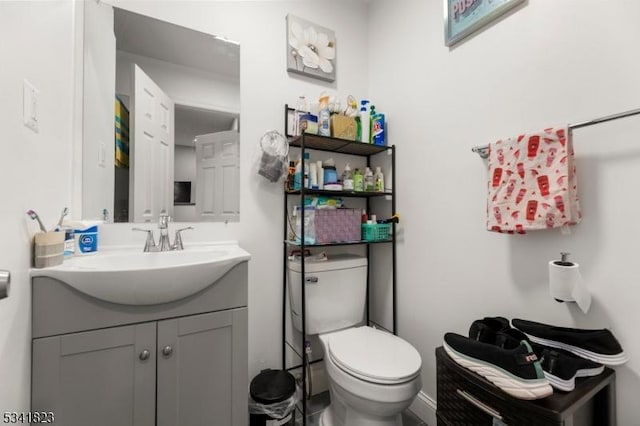 bathroom featuring toilet and vanity