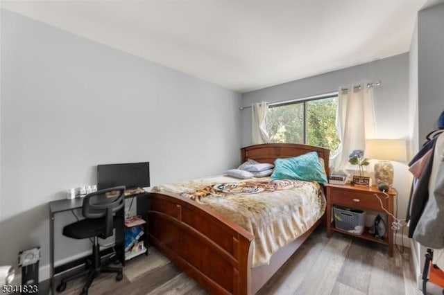 bedroom with wood finished floors