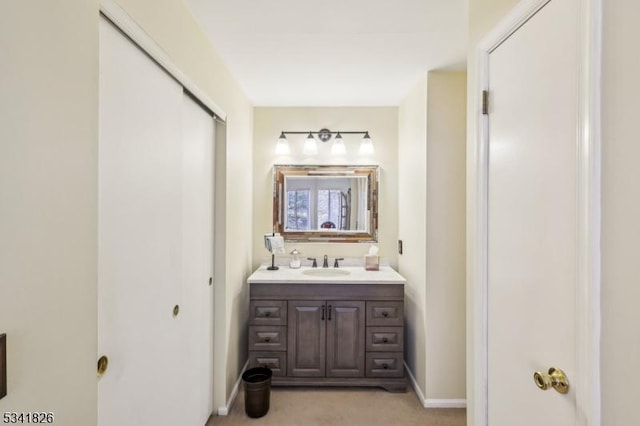 bathroom featuring baseboards and vanity