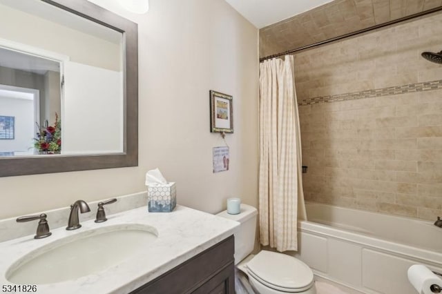 full bathroom with shower / tub combo with curtain, vanity, and toilet