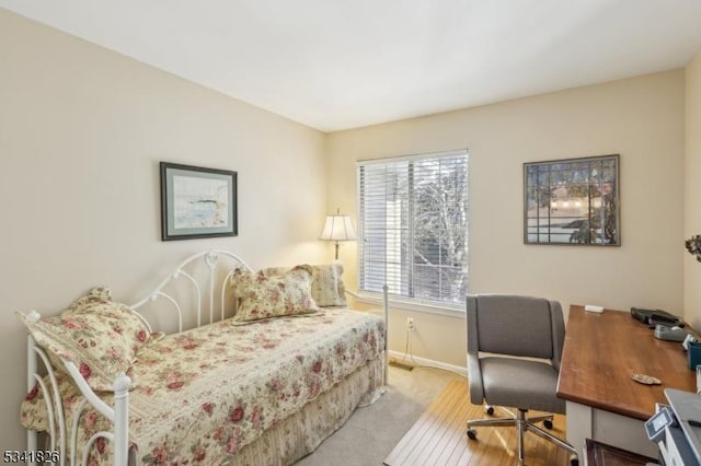 carpeted bedroom featuring baseboards