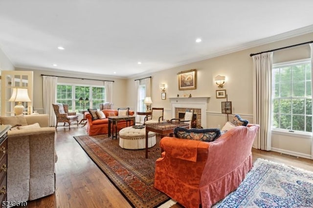 living room featuring recessed lighting, a fireplace, wood finished floors, visible vents, and crown molding