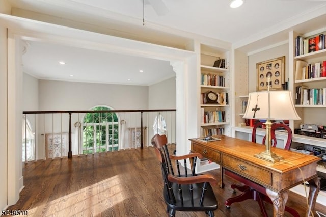 office area featuring built in features, crown molding, and wood finished floors