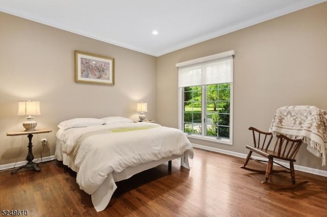 bedroom featuring dark wood-style floors, baseboards, ornamental molding, and recessed lighting