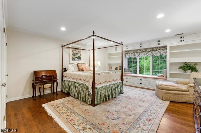 bedroom featuring baseboards, wood finished floors, and recessed lighting