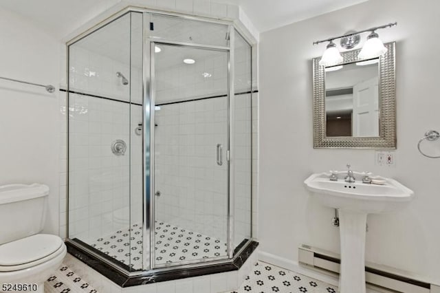 full bath with toilet, a stall shower, a baseboard heating unit, and tile patterned floors