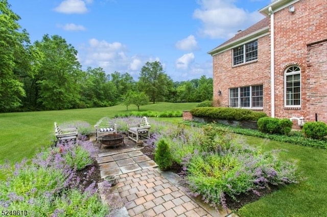 view of yard with an outdoor fire pit and a patio area