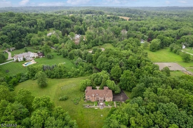 bird's eye view featuring a wooded view