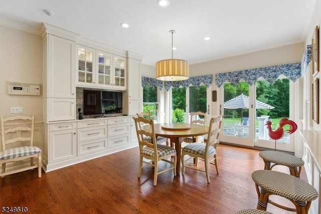 dining room featuring ornamental molding, recessed lighting, and dark wood finished floors