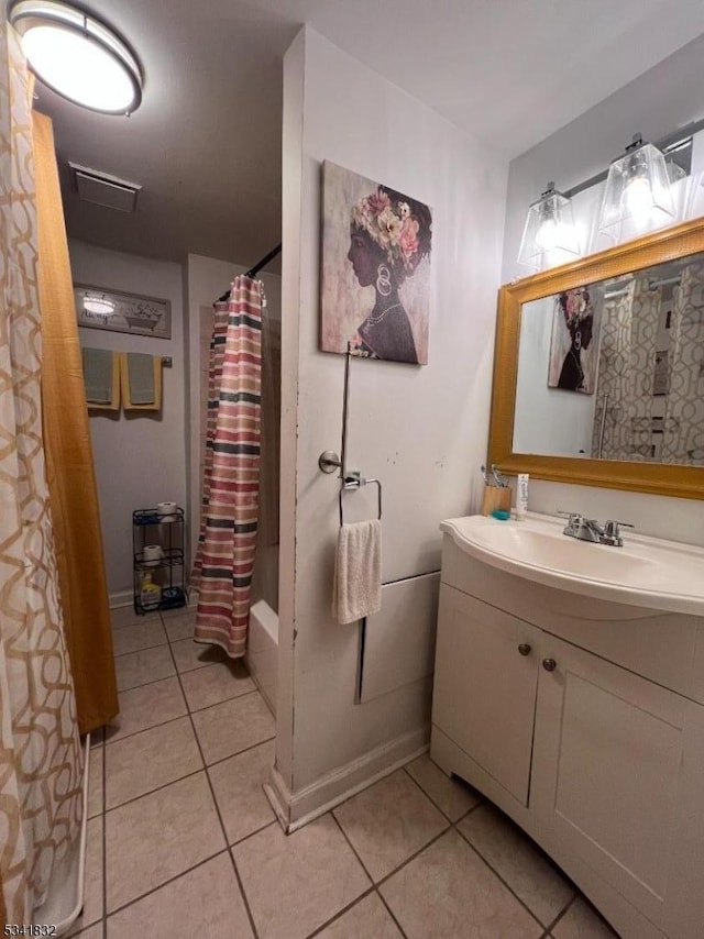 bathroom with baseboards, visible vents, tile patterned floors, shower / bath combination with curtain, and vanity