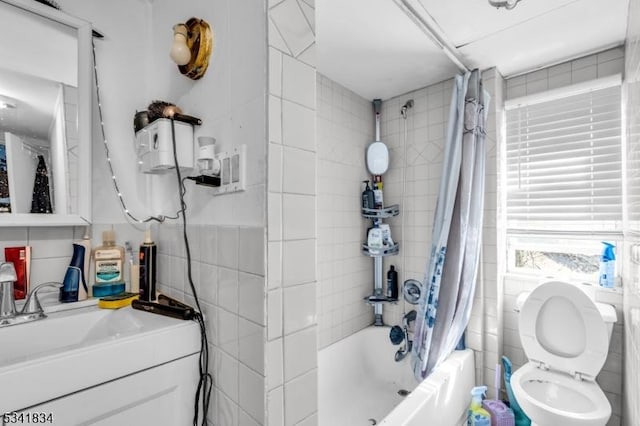 full bath with shower / bathtub combination with curtain, toilet, tile walls, and vanity