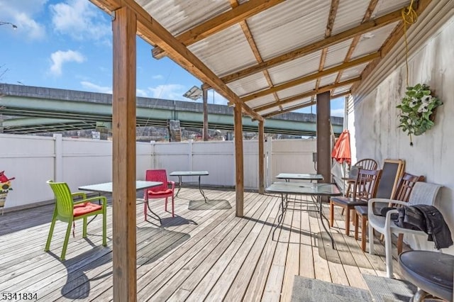 wooden terrace with fence and outdoor dining area